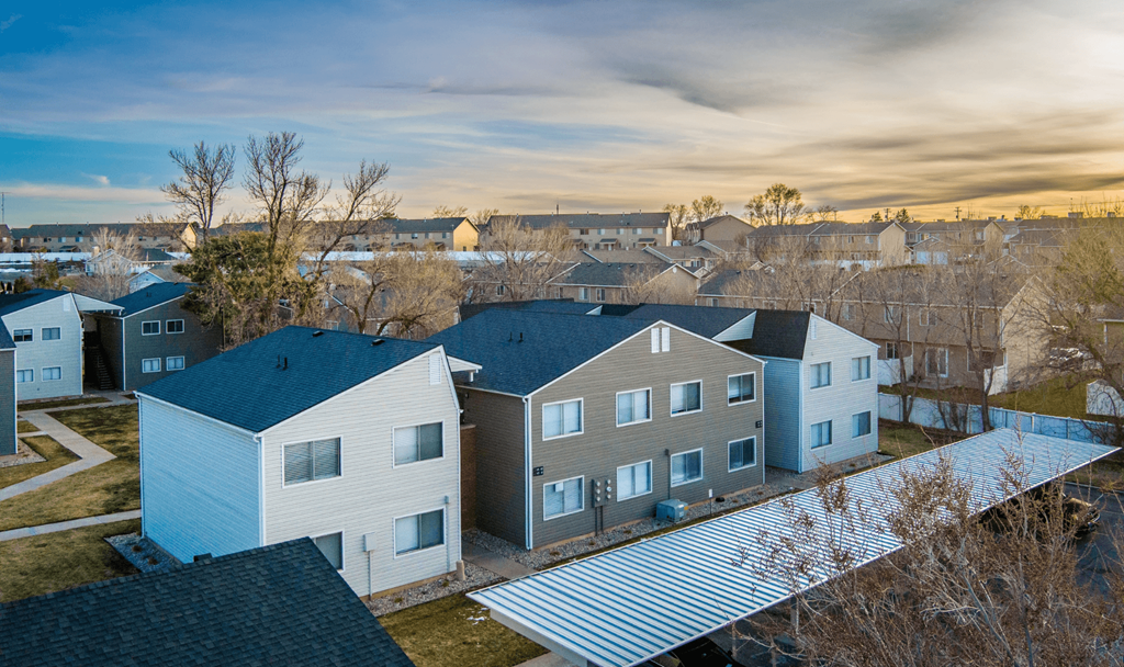 A row of houses with a grey roof.