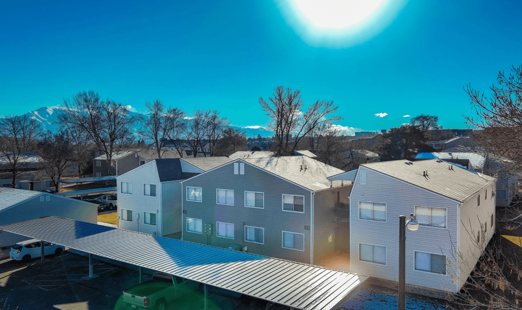 A sunny day in a residential area with houses and trees.
