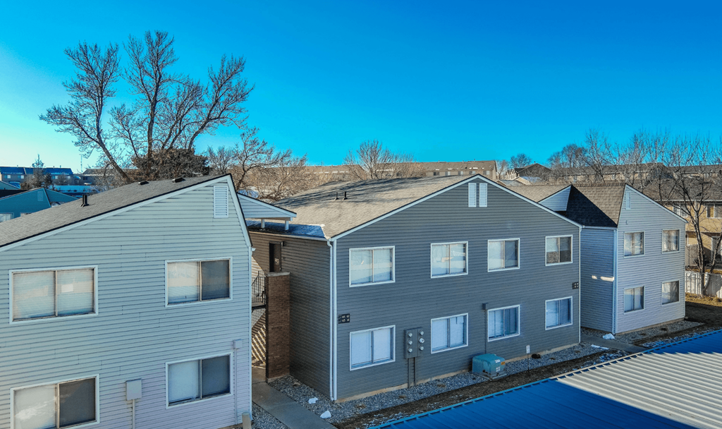 A row of houses with a blue sky above them.