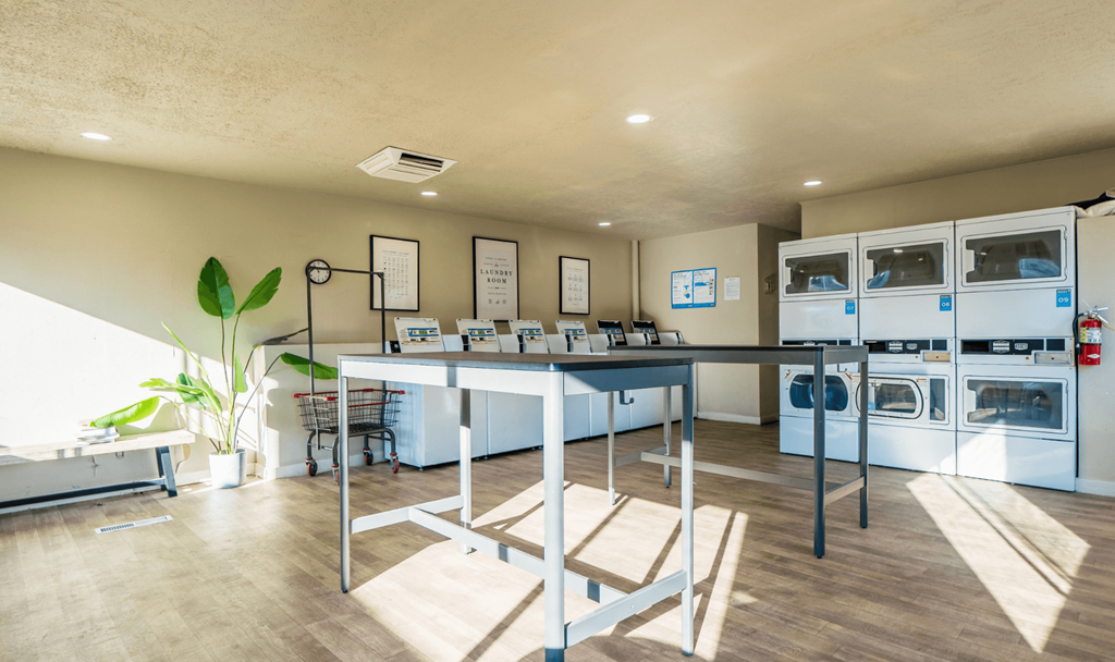 A kitchen with a table and chairs in the middle of the room.