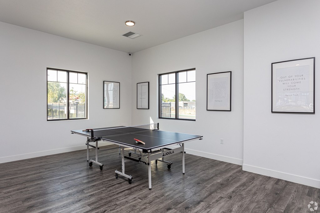 A room with a pool table and pictures on the wall.