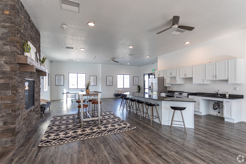 A modern kitchen with a dining area and a fireplace.