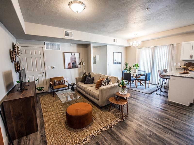 A living room with a couch, chairs, and a coffee table.