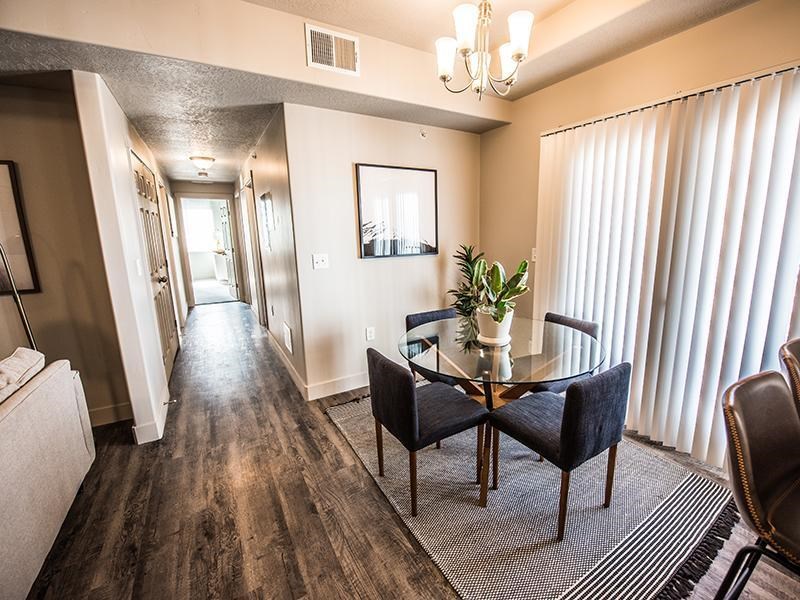 A dining room with a wooden table and chairs.