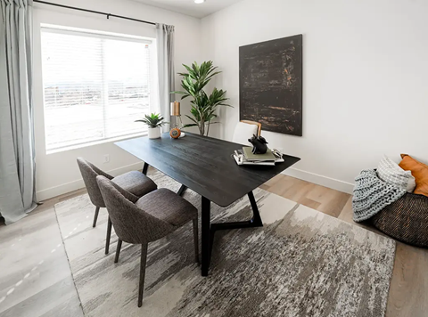 A modern dining room with a large table and chairs.