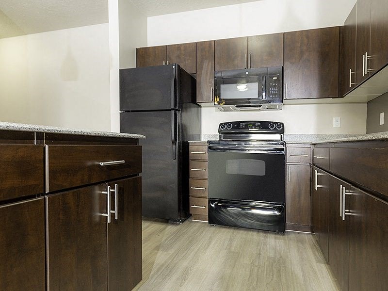 a kitchen with a black stove from The Lotus Apartments in Downtown Salt Lake City, Utah