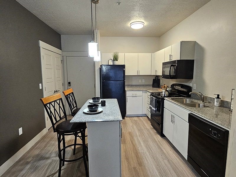 a kitchen with stools from The Lotus Apartments in Downtown Salt Lake City, Utah