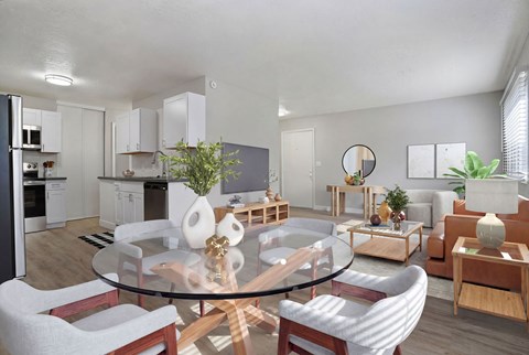 A modern living room with a glass table and white chairs.