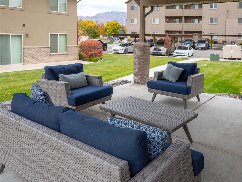 a patio with couches and chairs and a table