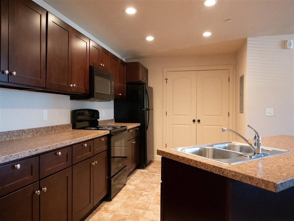a kitchen with granite counter tops and a sink