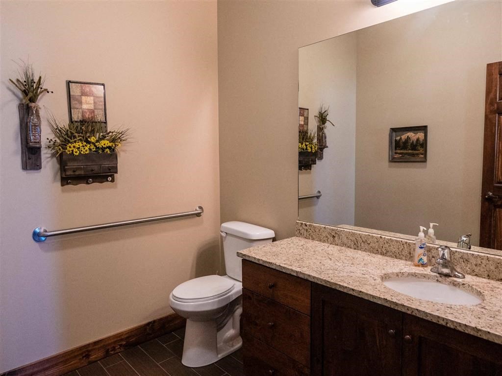 a bathroom with a toilet and a sink and a mirror
