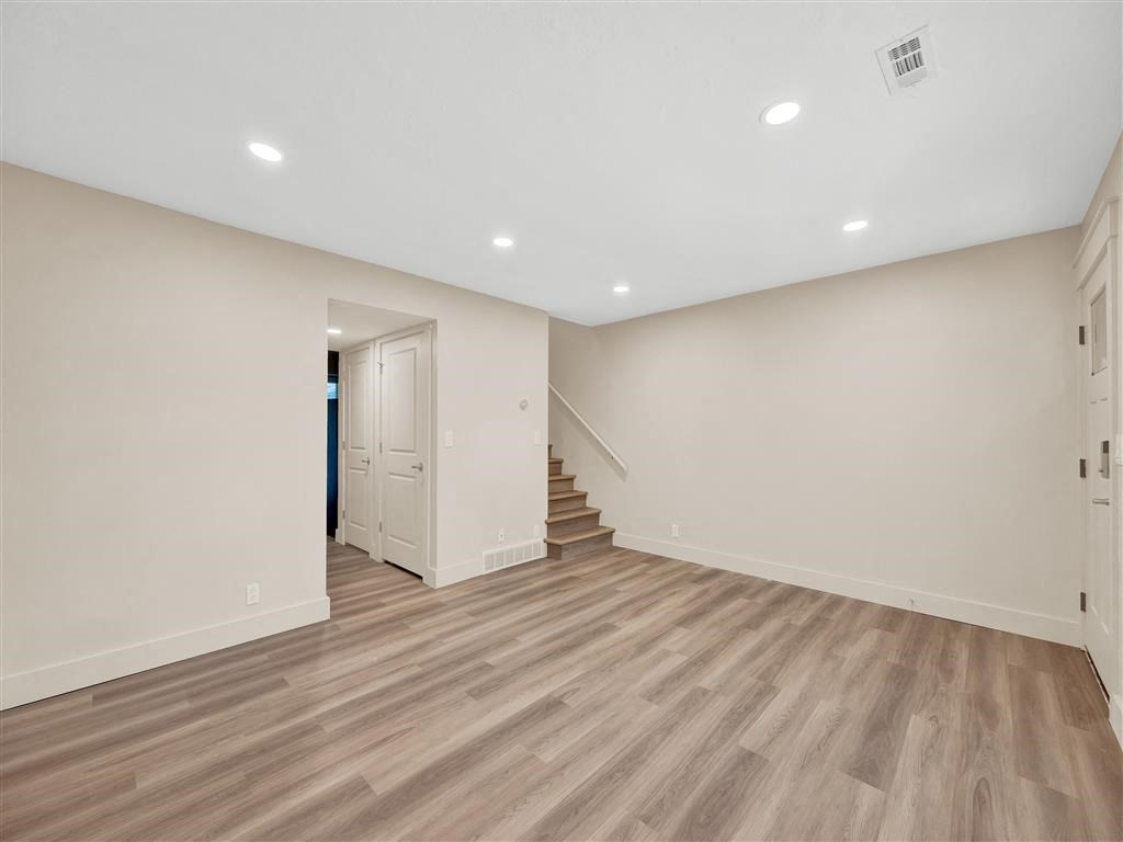 a living room with a staircase and a white door