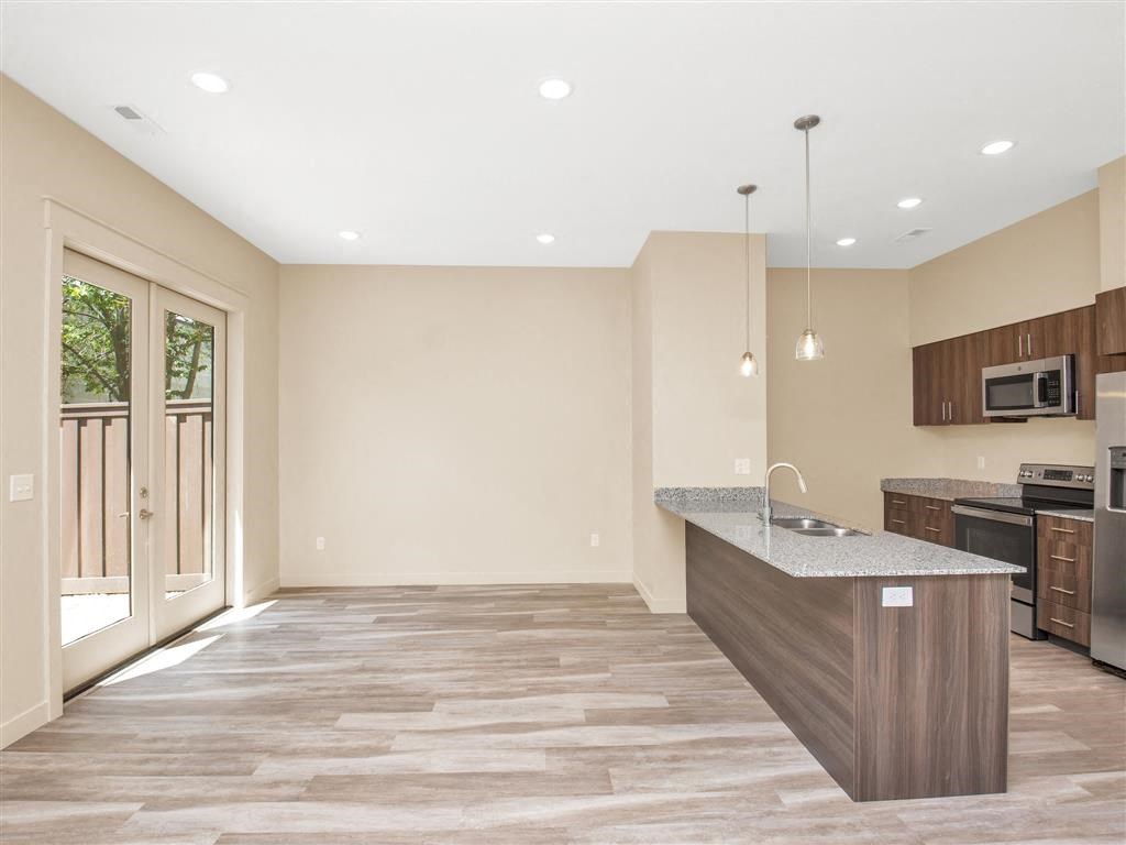 a kitchen with an island and a door to a patio