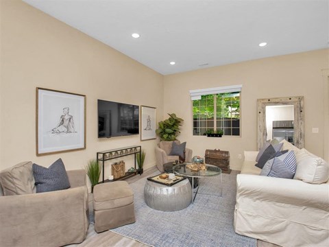 a living room with couches and chairs and a television