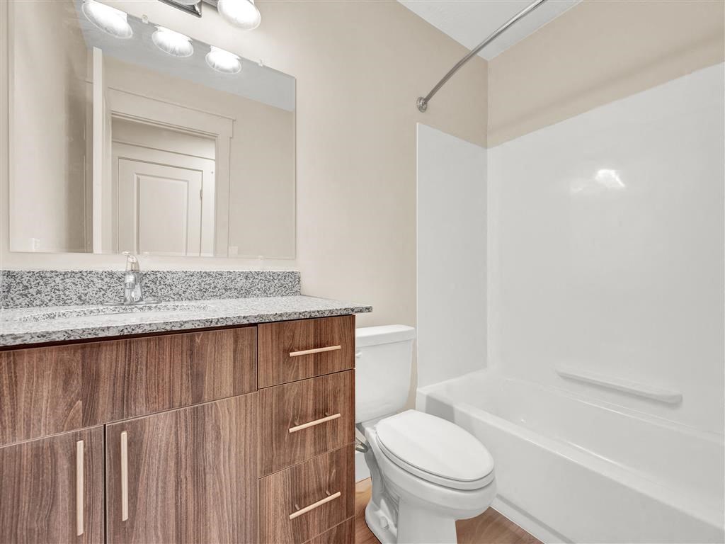 a bathroom with a toilet and a mirror