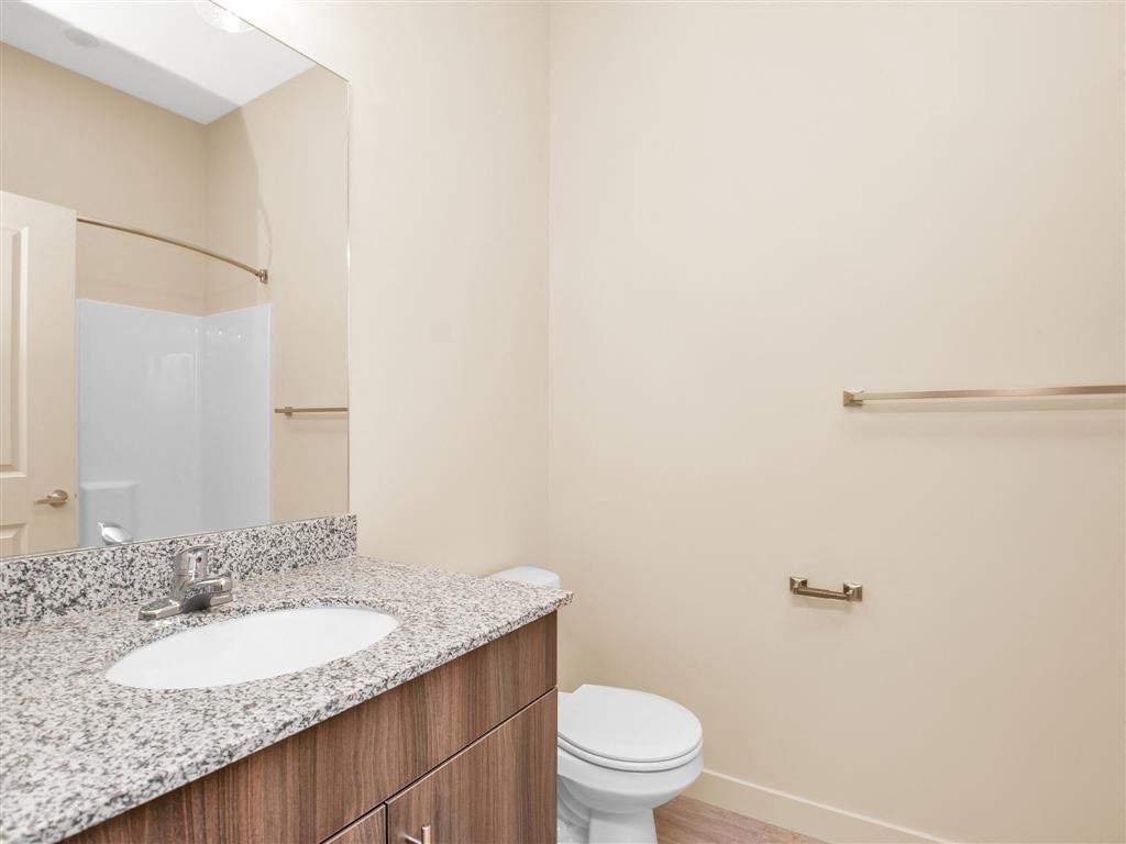 a bathroom with a sink toilet and a mirror