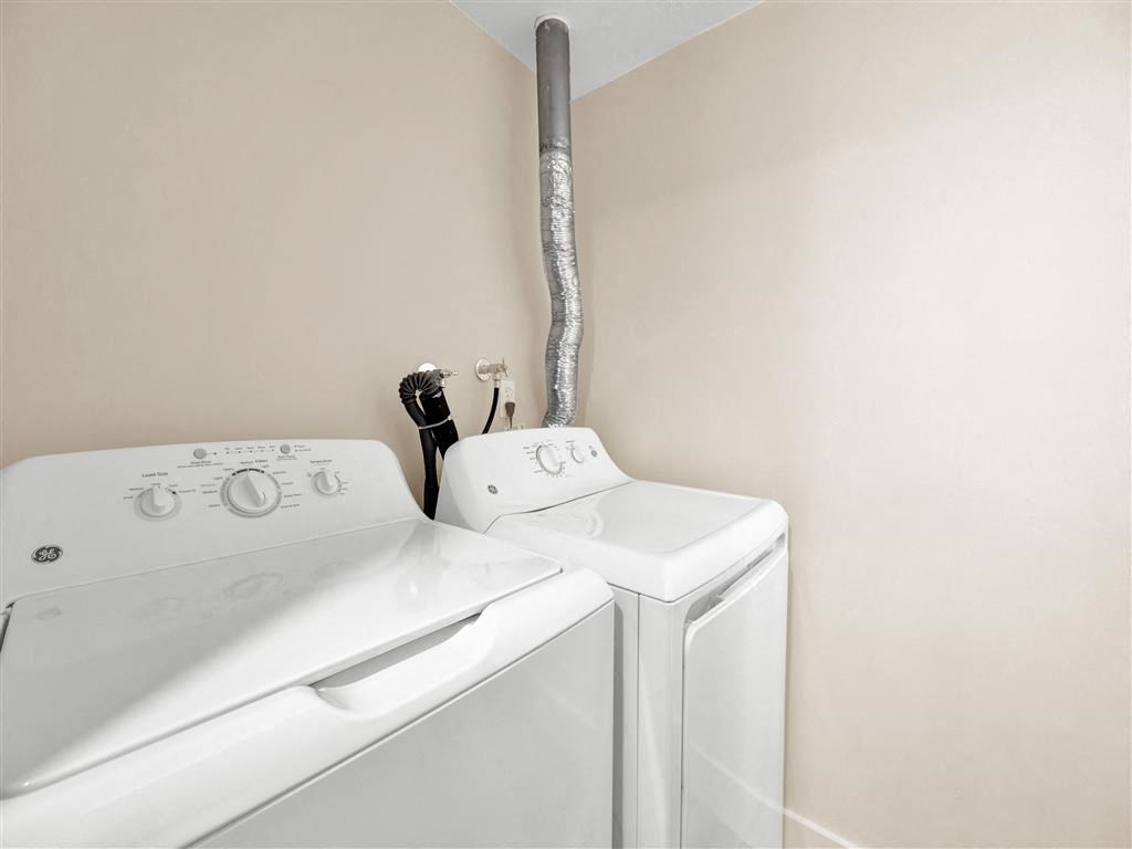 a white washer and dryer in a laundry room with a white