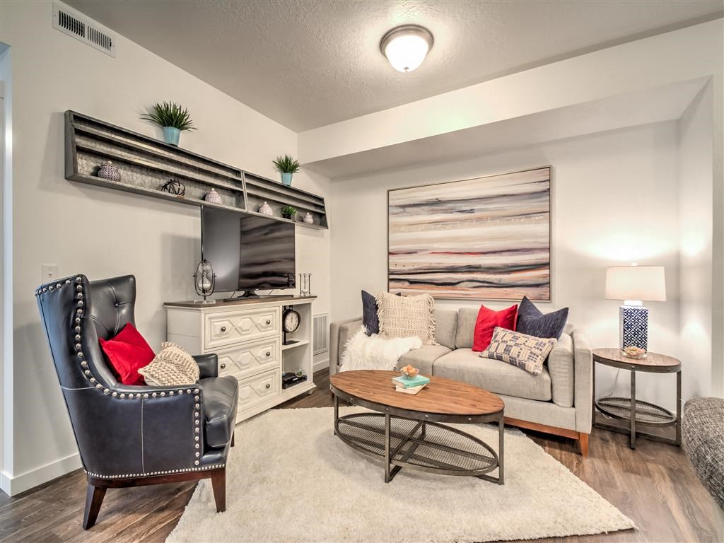 a living room with a couch and a table at Aderra apartments for rent in Roy, Utah