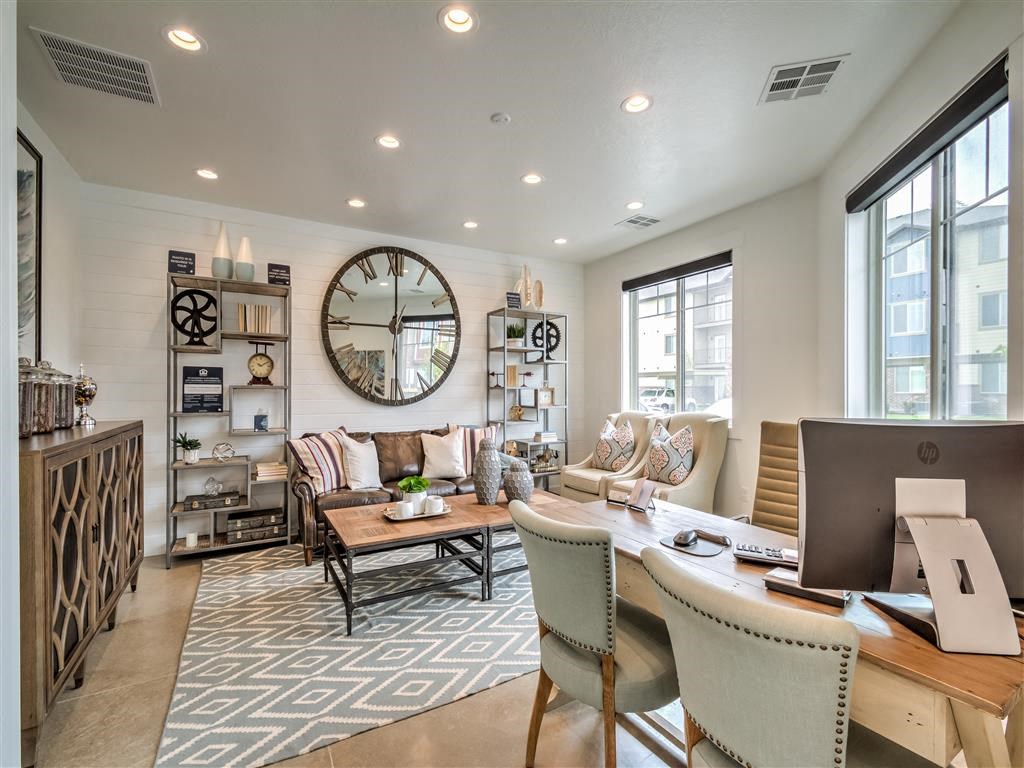 a large living room with a large clock on the wall at Aderra apartment complex available to rent in Roy, Utah