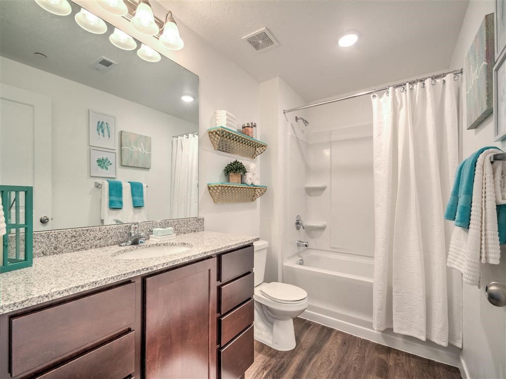 a bathroom with a shower, toilet and sink at Aderra in Roy, Utah
