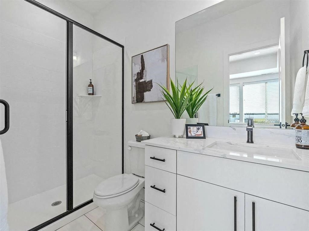 a bathroom with a shower and a sink and a toilet