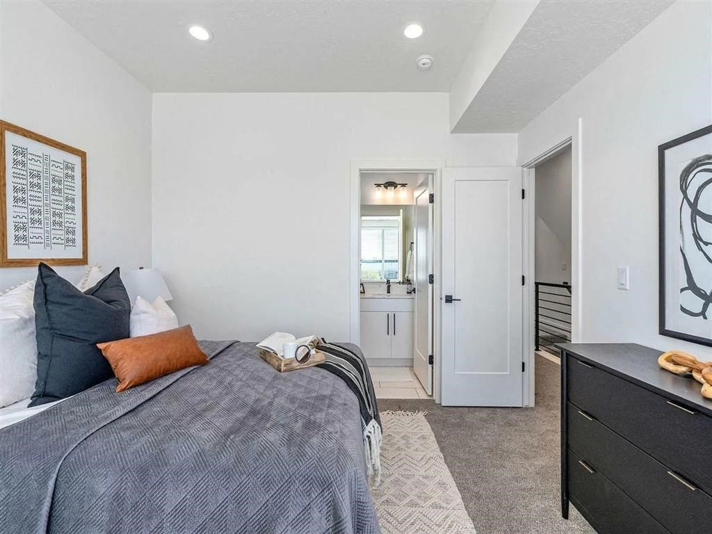 a bedroom with a bed and a door to a bathroom