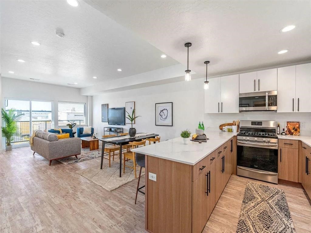 a kitchen and living room with a table and chairs
