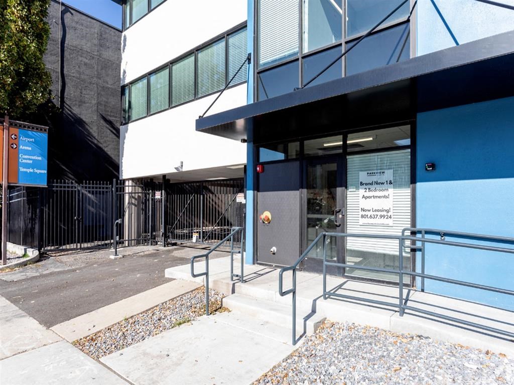 the entrance to a building with stairs and a glass door