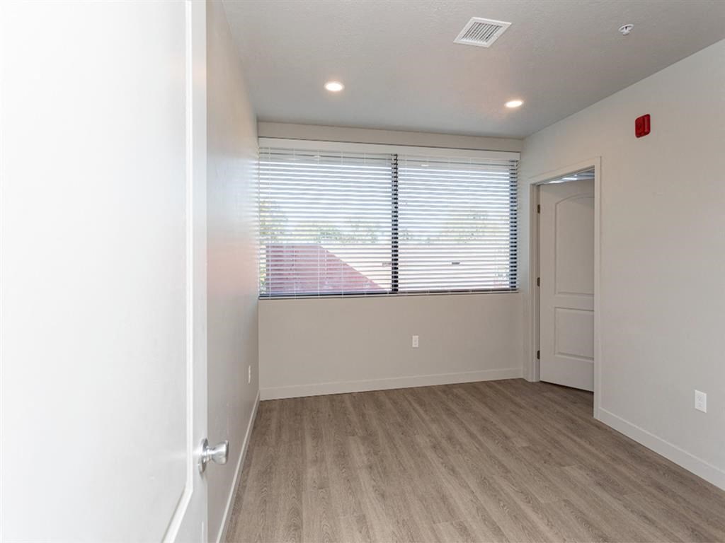 a living room with a large window and a door