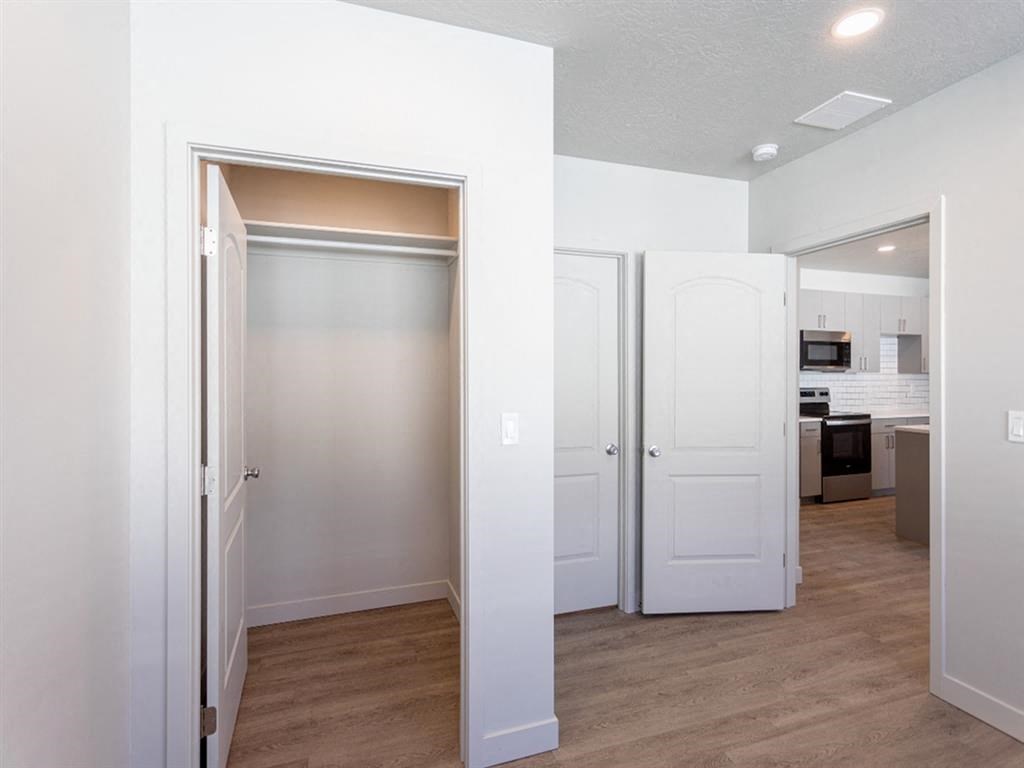 a renovated living room and kitchen with white doors
