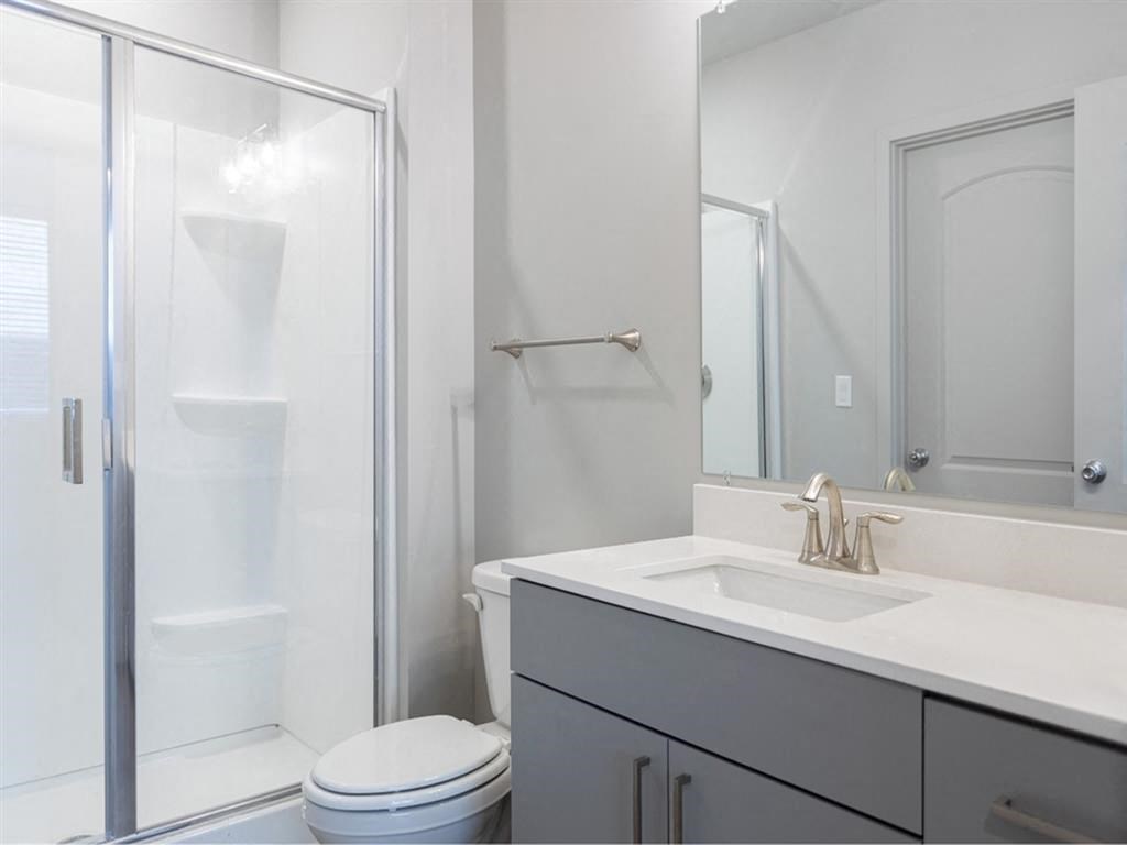 a bathroom with a sink toilet and a shower