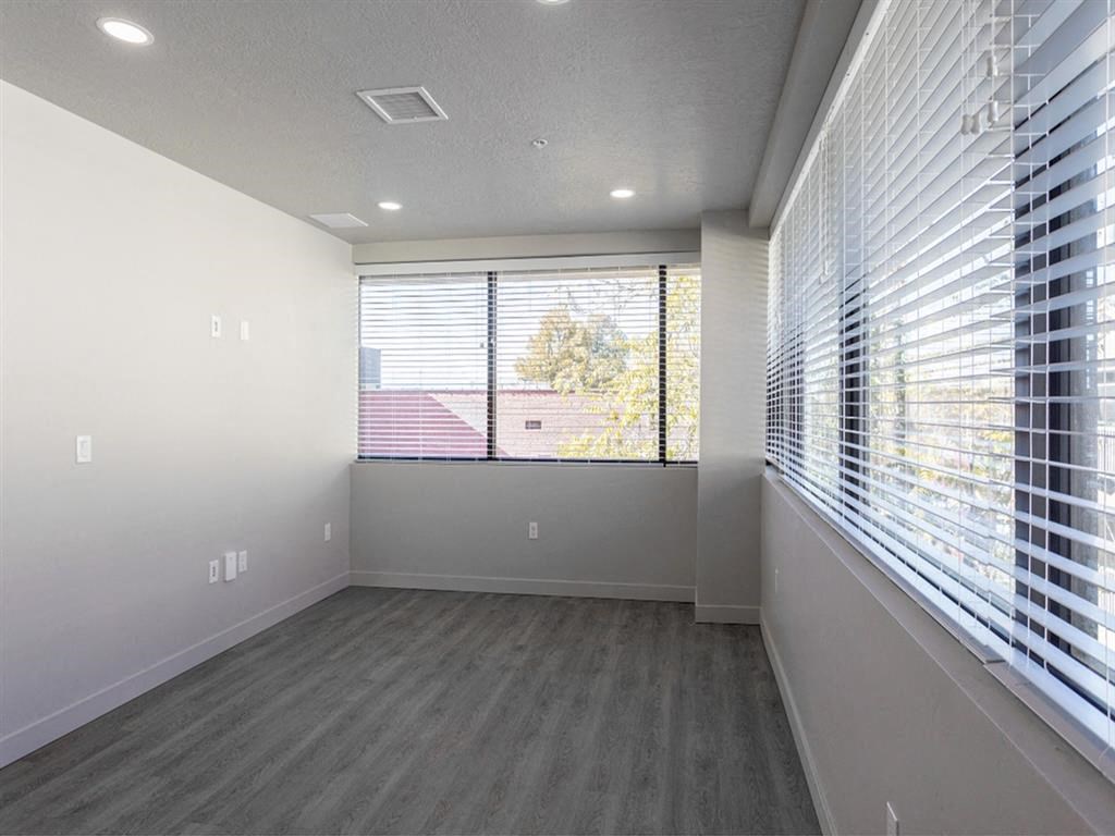 an empty living room with a large window