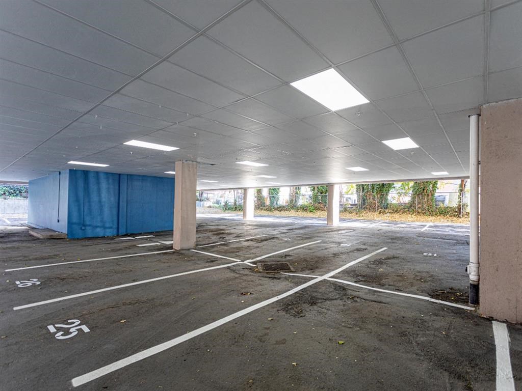 an empty parking lot with a blue curtain