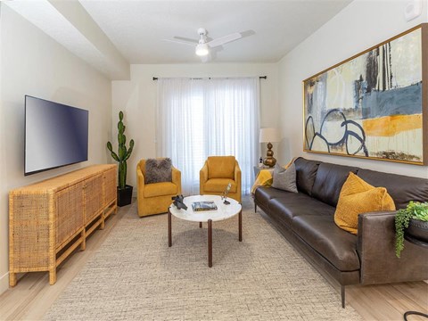 a living room with a leather couch and a coffee table