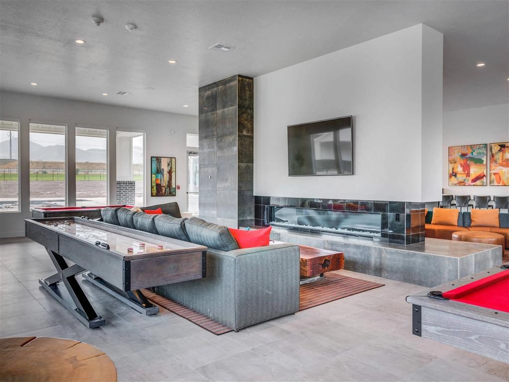 the living room has a pool table and a fireplace  at Affinity 56 Apartments in West Jordan, Utah