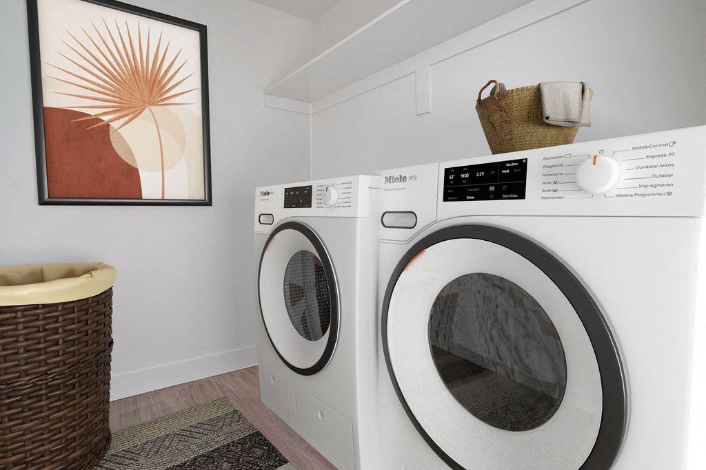 a washer and dryer in a laundry room with a painting on the wall