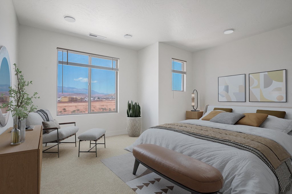 a bedroom with a bed and a desk with two chairs