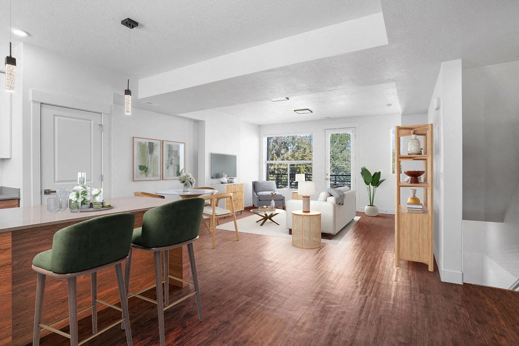 a living room and dining room with a table and chairs