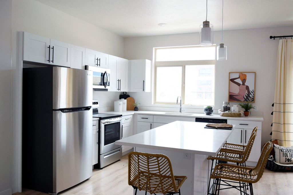 a kitchen with white cabinets and a white counter top