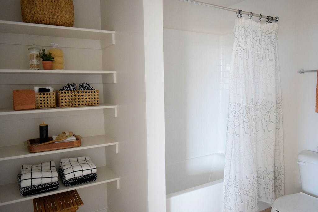 a bathroom with white walls and a white shower curtain