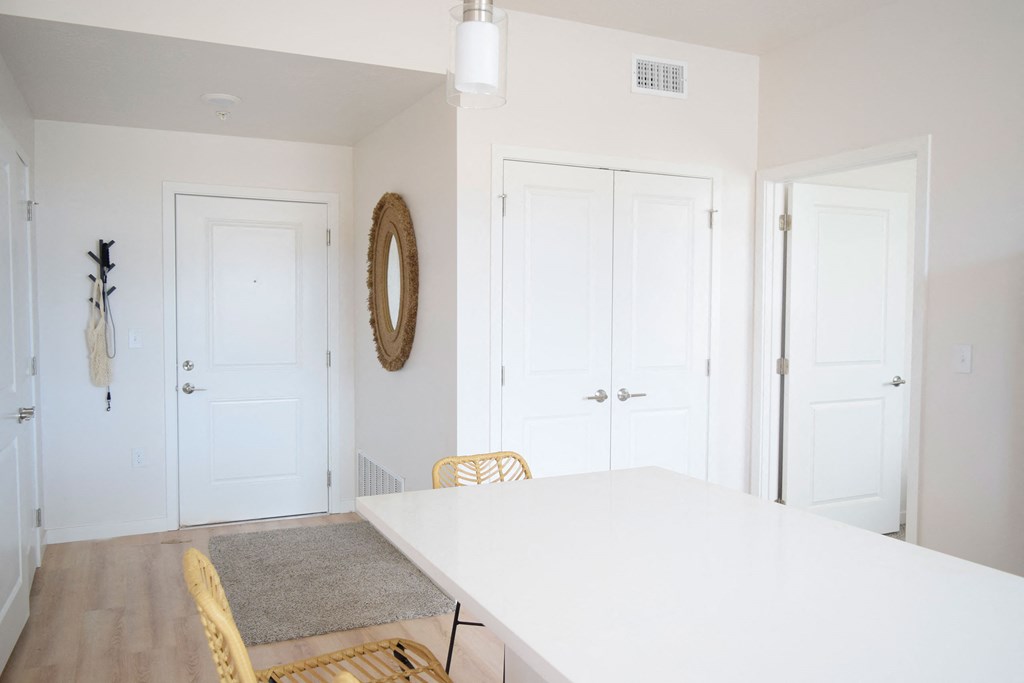 a dining room with a white table and yellow chairs