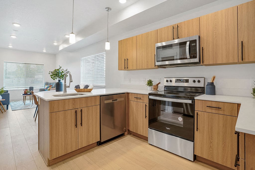 a kitchen with wooden cabinets and stainless steel appliances