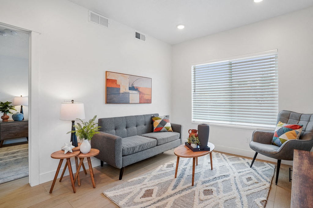 a living room with a couch and two tables