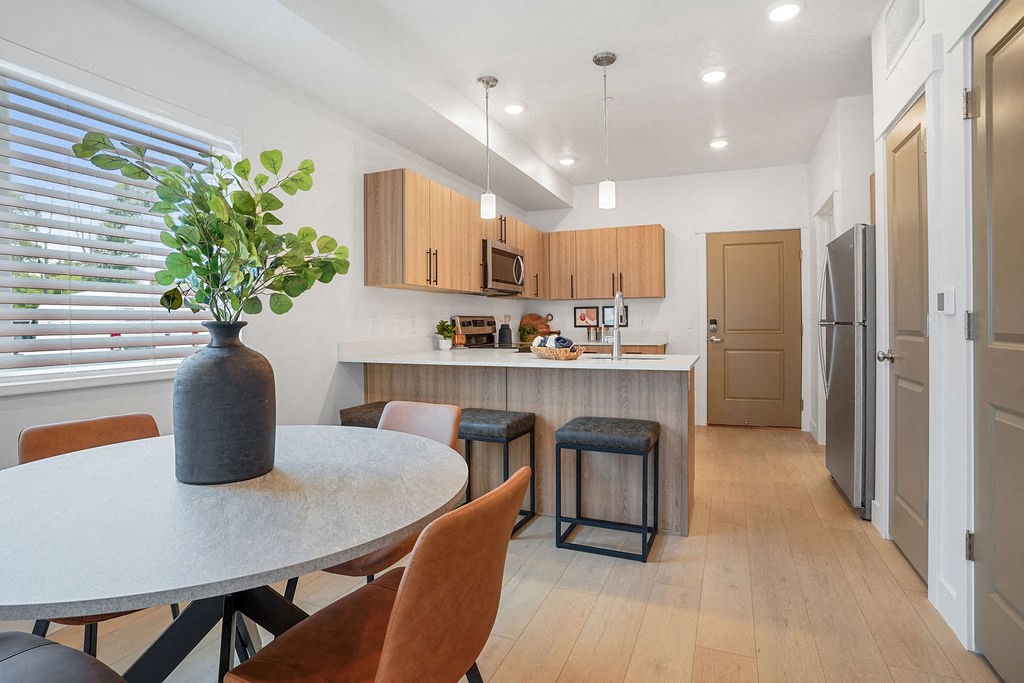 a kitchen and dining area with a table and chairs