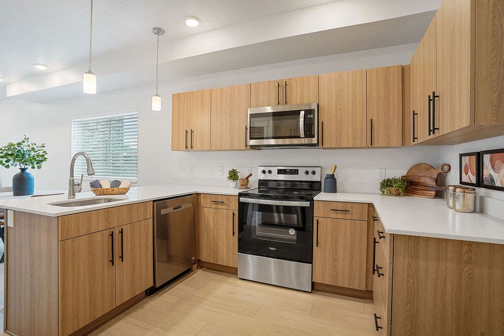a kitchen with wooden cabinets and stainless steel appliances
