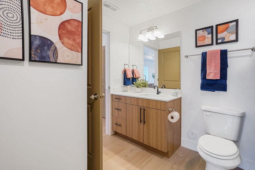 a bathroom with a toilet sink and a mirror