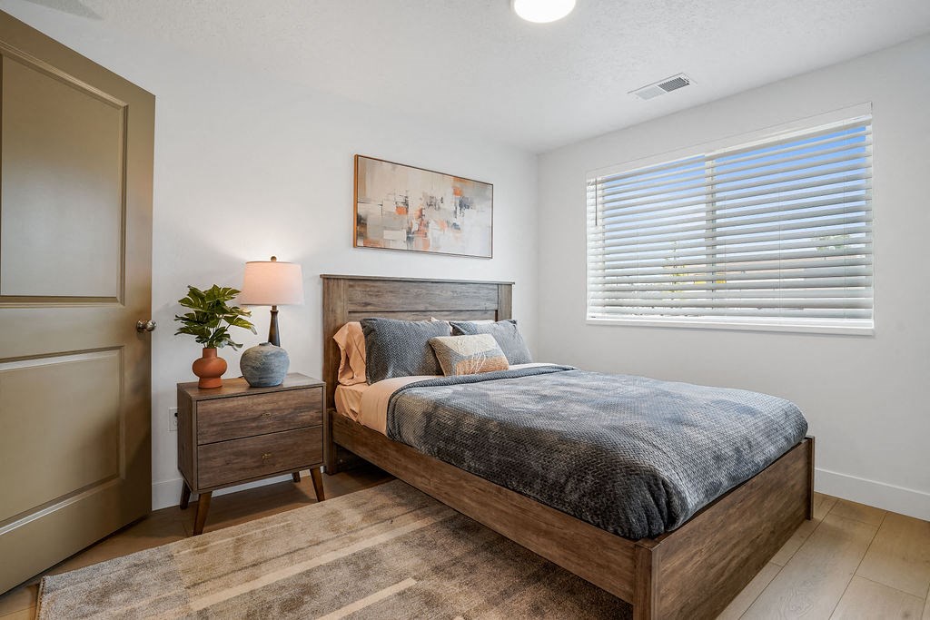 a bedroom with a bed and a window