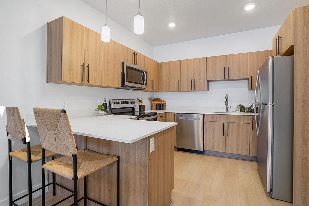 a kitchen with wooden cabinets and stainless steel appliances