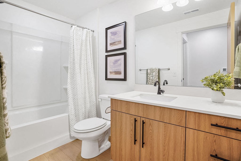 a bathroom with a sink toilet and a mirror