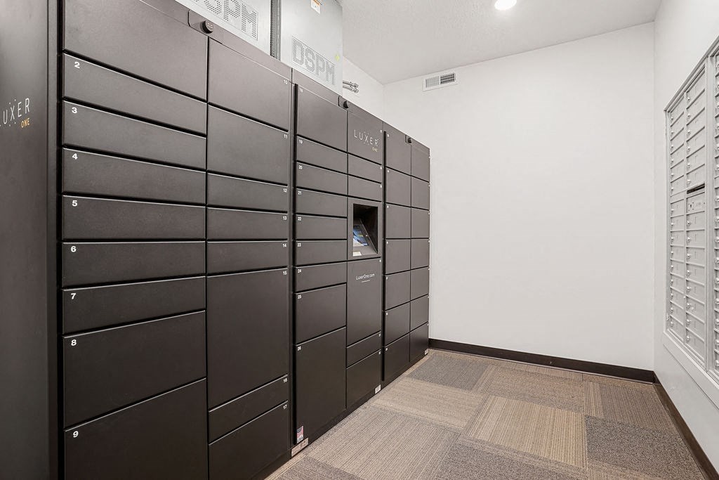 a row of black lockers in a white room